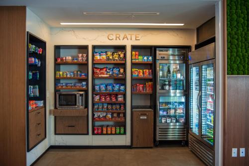 a grocery store aisle with a refrigerator and drinks at Courtyard by Marriott Lake City in Lake City
