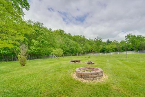 a field with a fire pit in the grass at Hike, Fish and More Home on 5 Acres in Crossville! in Crossville