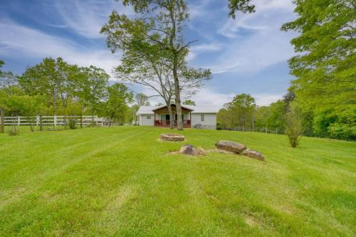 a field with rocks in front of a house at Hike, Fish and More Home on 5 Acres in Crossville! in Crossville