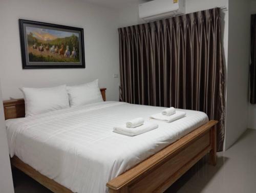 a bedroom with a bed with two towels on it at VS Place in Nonthaburi