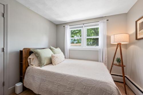 a bedroom with a bed and a window at 7 Raymond Avenue South Yarmouth -The Sandlot Shanty in South Yarmouth