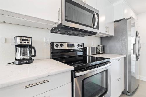 a kitchen with a stove top oven and a microwave at The Hudson Hideout in Hudson
