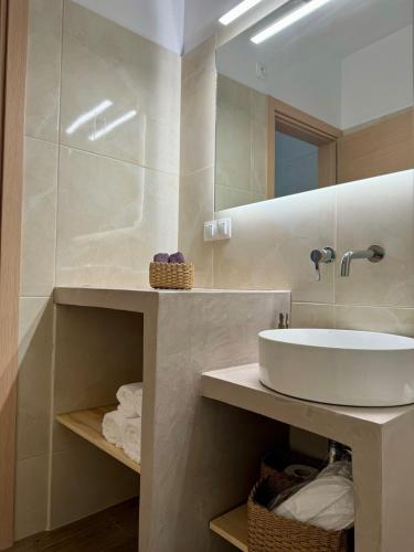 a bathroom with a sink and a mirror at Moretti Studio2 in Gythio