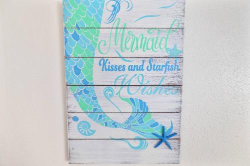 a sign that says mermaid kisses and sparkle wine at The Hudson Hideout in Hudson