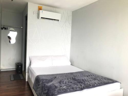 a bedroom with a bed in a white room at Contana By Travelink in Patuk