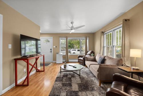 a living room with a couch and a table at Bo's Big Green Charming Retreat Hot Tub Games in Billings