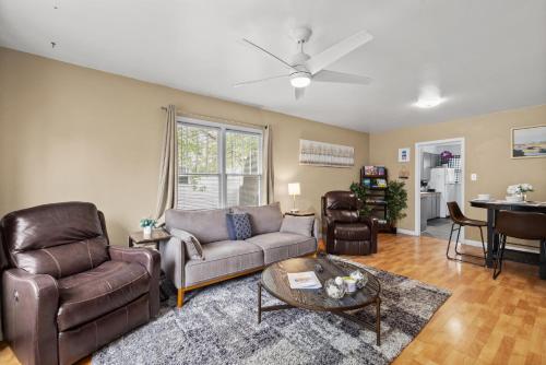 a living room with a couch and chairs and a table at Bo's Big Green Charming Retreat Hot Tub Games in Billings