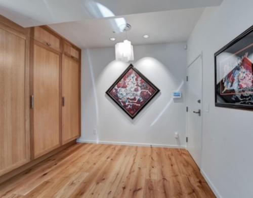 an empty living room with a painting on the wall at Elevated Living in the Hills in Portland