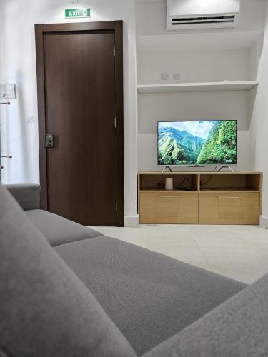 a living room with a flat screen tv on a entertainment center at Peacful Perch in Sliema