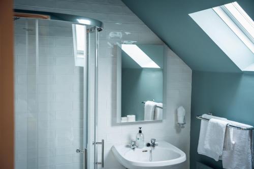 a bathroom with a sink and a shower at Móinéir House in Kilkee