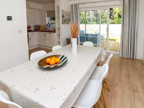 a kitchen and dining room with a white table and chairs at Whitfield P1 in Yarmouth