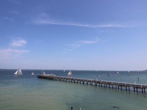 a dock with sailboats on the water with a pier at Whitfield P1 in Yarmouth