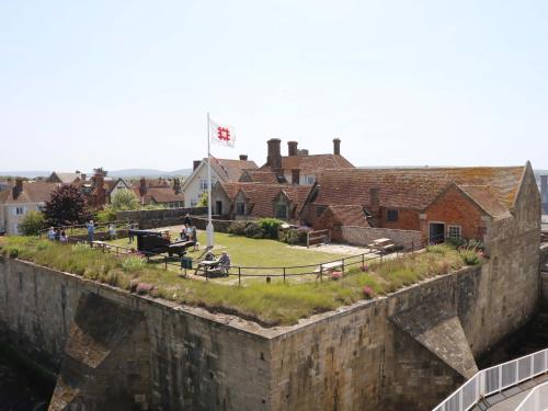 an old stone wall with a park and buildings at Whitfield P1 in Yarmouth
