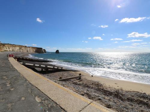 a beach with a pier and the ocean at Whitfield P1 in Yarmouth