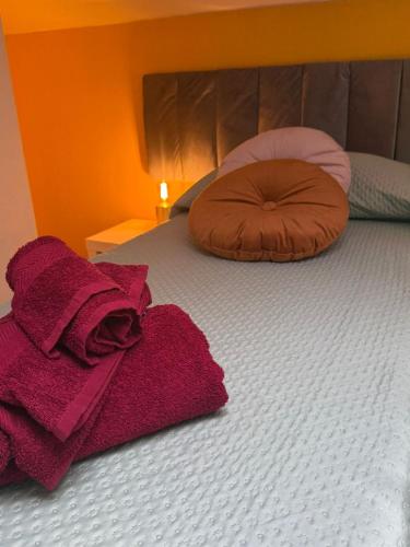 a bed with red towels on top of it at Casetta Romana Alloggio Turistico in Borghesiana 