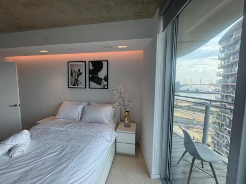 a bedroom with a bed and a large window at High Floor Modern 1BR Stunning Views Balcony AC Free Parking in London