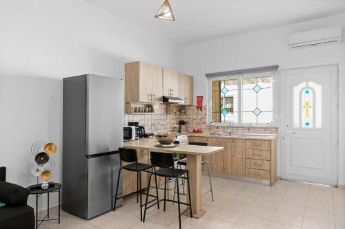 a kitchen with a stainless steel refrigerator and a table at Malona Nostalgia in Malona Village