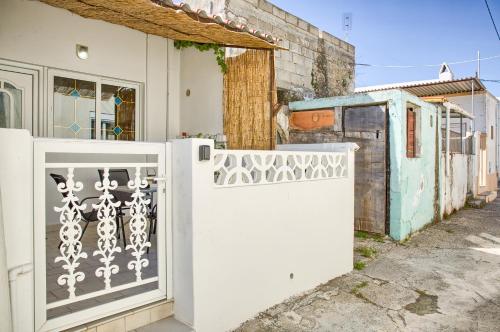 a white gate in front of a house at Malona Nostalgia in Malona Village