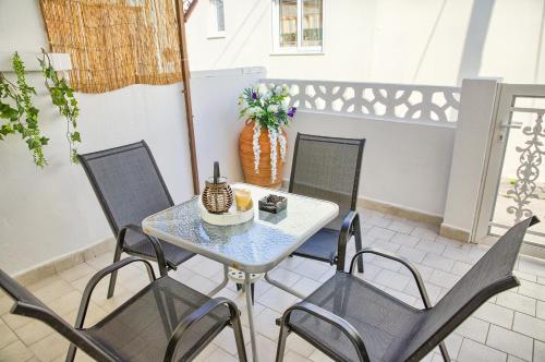 a table and four chairs on a patio at Malona Nostalgia in Malona Village