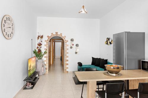 a living room with a table and a refrigerator at Malona Nostalgia in Malona Village