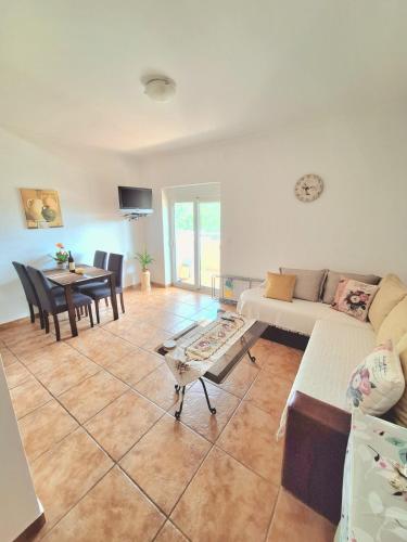 a living room with a couch and a table at Sea Whisper Apartment in Budva