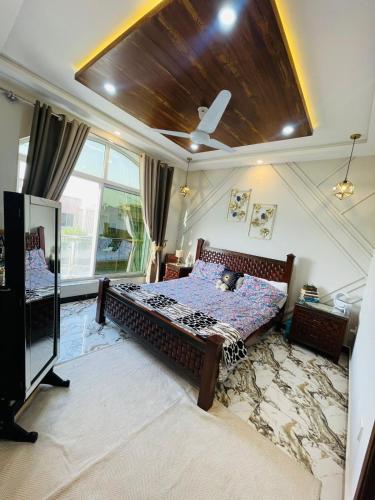 a bedroom with a bed and a ceiling at Comfort corner in Rawalpindi