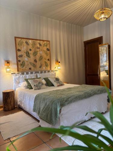 a bedroom with a large bed with a large headboard at Varanda de Coimbra in Penacova