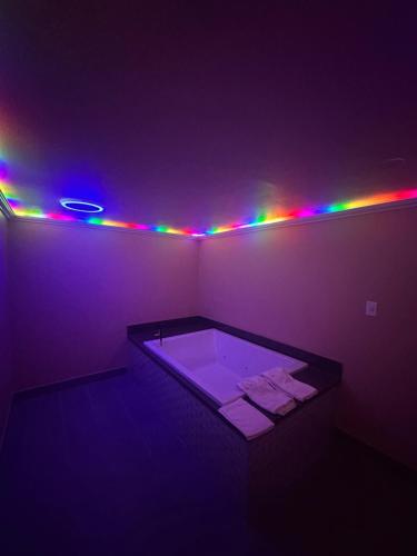 a purple room with a tub with lights on it at Stardust inn in Azusa
