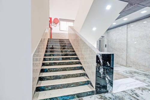 a staircase in a building with marble floors at Hotel O Yash Residency in Mumbai