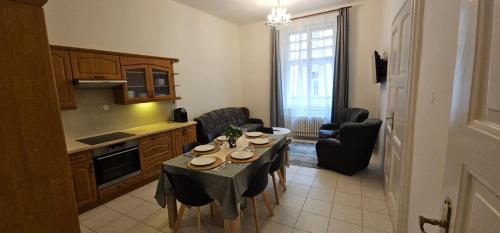 a kitchen with a table and chairs in a room at Old Town Home Prague in Prague