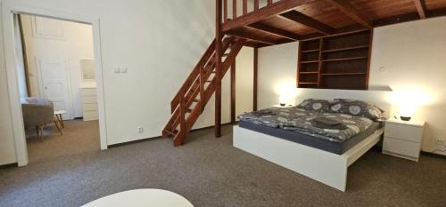 a bedroom with a large bed and a staircase at Old Town Home Prague in Prague