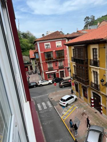 a view from a window of a city street with cars at La Casina del Sella in Ribadesella