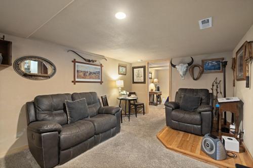 a living room with a couch and a chair at Bo's Old West Den with Off Street Parking in Billings
