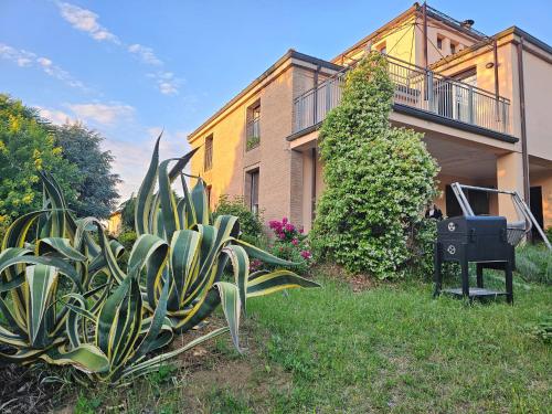a house with a plant in front of it at Casa VINCENZO 130 mq con portico ed ingresso esclusivo dal giardino in Felino