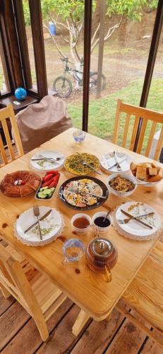 a wooden table with plates of food on it at GreenField Resort in Yeghegnadzor