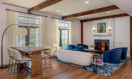 a living room with a table and chairs and a fireplace at The Brunswick Hotel in Brunswick