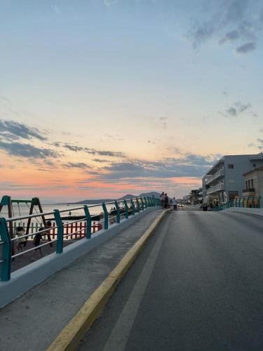a road with a fence on the side of a bridge at Vrontas House in Neapolis