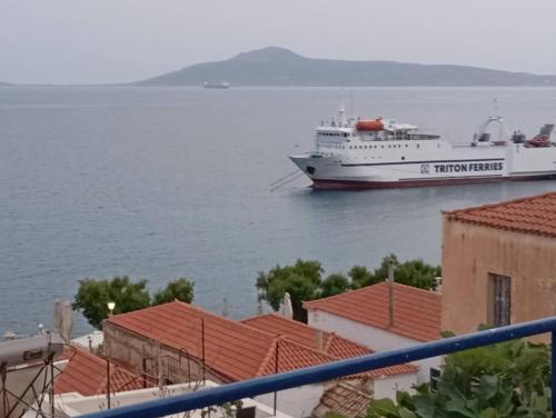 a cruise ship in the water next to buildings at Vrontas House in Neapolis