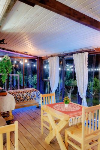 a dining room with a table and chairs on a porch at GreenField Resort in Yeghegnadzor