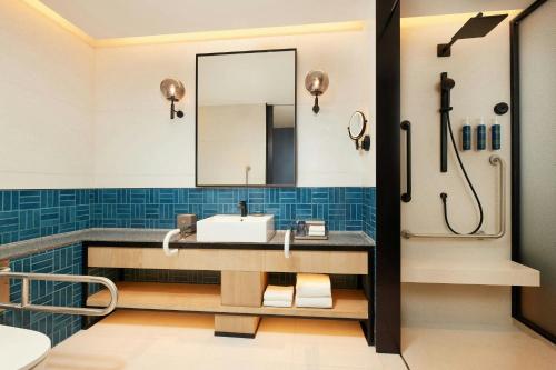 a bathroom with a sink and a mirror at Four Points by Sheraton Shanghai International Tourism and Resorts Zone in Nanhui