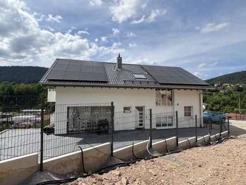 a house with solar panels on top of it at Waldklang Panorama in Alpirsbach