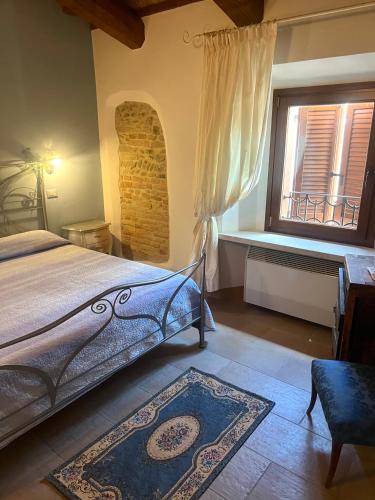 a bedroom with a bed and a window at Locanda Delle Fate in San Giovanni in Marignano