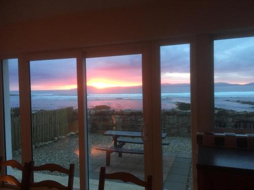 a view of a sunset from the balcony of a house at Sea View in Balnacart