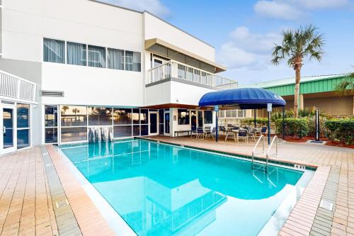 a swimming pool in front of a building at Pelican Beach Resort 504 in Destin