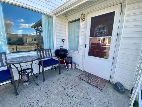 a front door of a house with a table and chairs at Bo's Copper City Charmer, easy Freeway Access, open floorplan in Butte