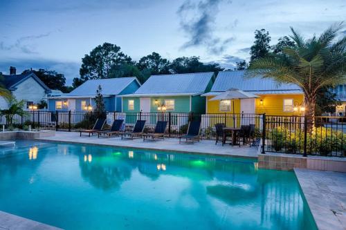 a swimming pool in front of a house at Quaint Cottage with Private Pool-Walk to Everything in St. Augustine