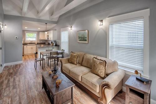 a living room with a couch and a table at Quaint Cottage with Private Pool-Walk to Everything in St. Augustine