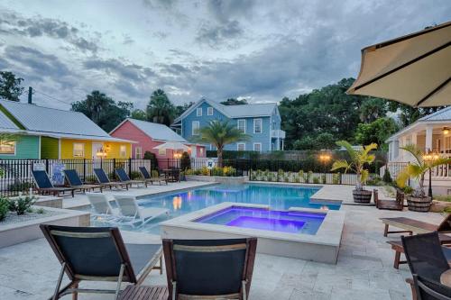 a swimming pool with chairs and a house at Quaint Cottage with Private Pool-Walk to Everything in St. Augustine