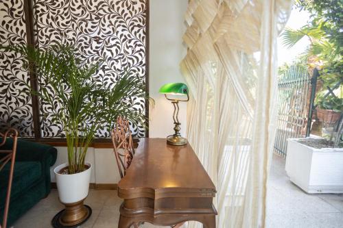 a room with a table with a lamp and plants at Therme Appiae in Rome