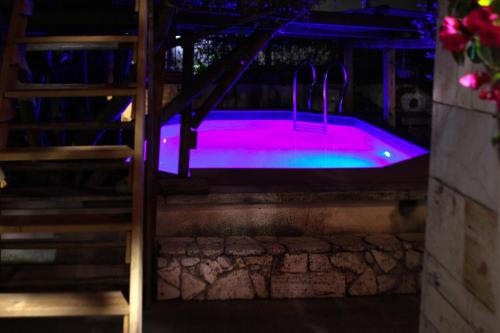 a hot tub with purple lights in a room at Therme Appiae in Rome